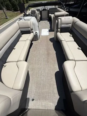 Slide: The Image of 2021 Barletta Boats C24Q interior with spacious seating and beige upholstery. - 4
