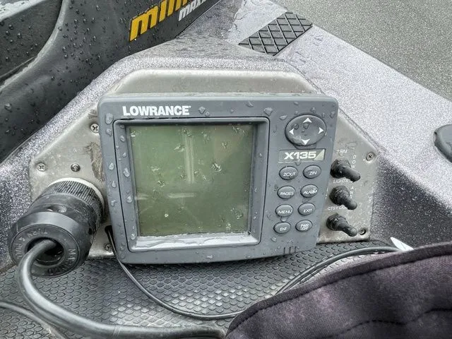 Slide: The Image of Lowrance X135 fishfinder on 2008 Bee Line Super Vee boat, wet with raindrops. - 13