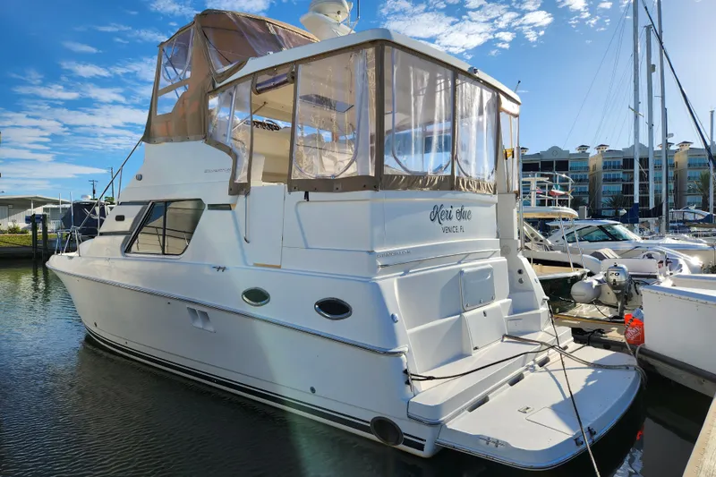The Image of 2001 Silverton 392 Motor Yacht docked at marina under clear blue sky. - 0