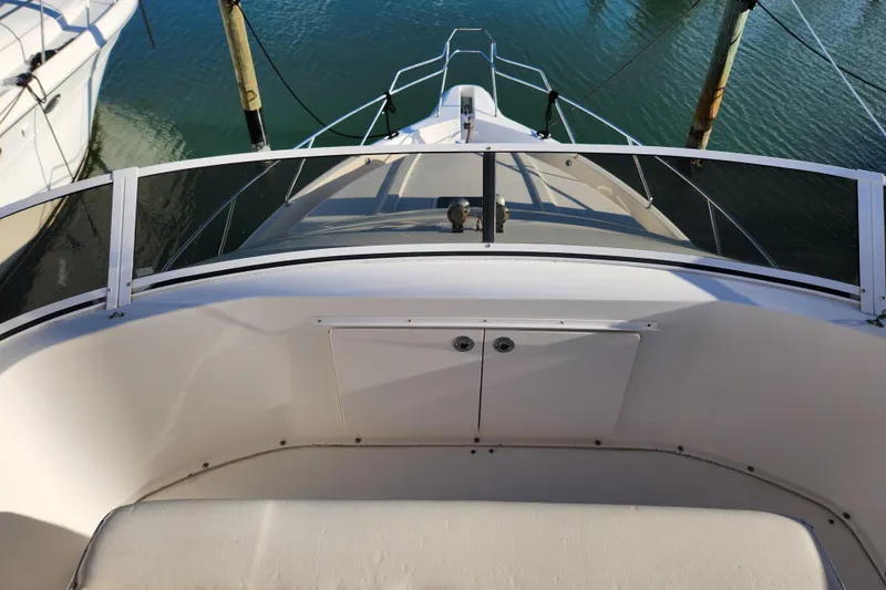 Slide: The Image of 2001 Silverton 392 Motor Yacht bow view with railing and calm water. - 13