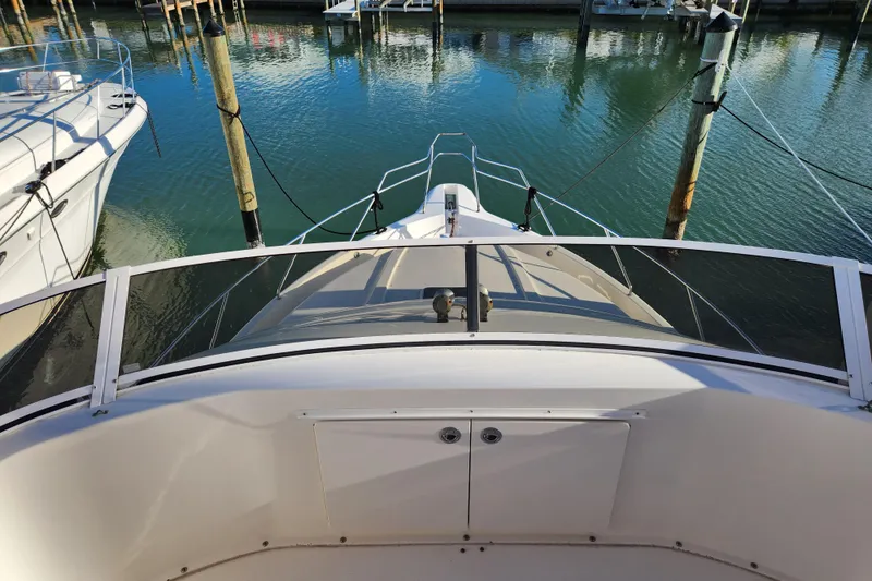 Slide: The Image of 2001 Silverton 392 Motor Yacht docked in a marina, viewed from the deck. - 14
