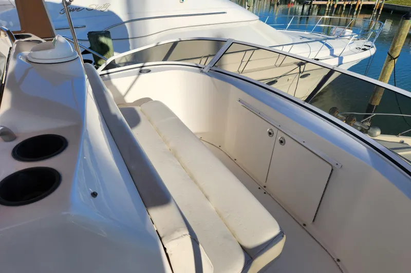 Slide: The Image of 2001 Silverton 392 Motor Yacht interior with seating and storage, docked at marina. - 15