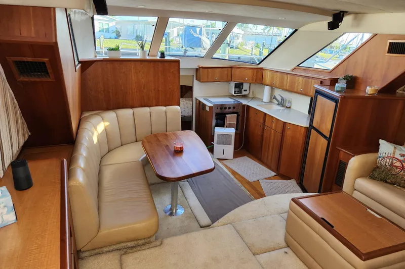 Slide: The Image of Interior of 2001 Silverton 392 Motor Yacht with cozy seating and modern kitchen amenities. - 16