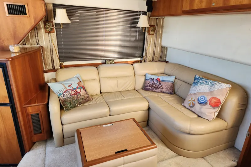 Slide: The Image of Interior of 2001 Silverton 392 Motor Yacht with beige leather seating and decorative pillows. - 17