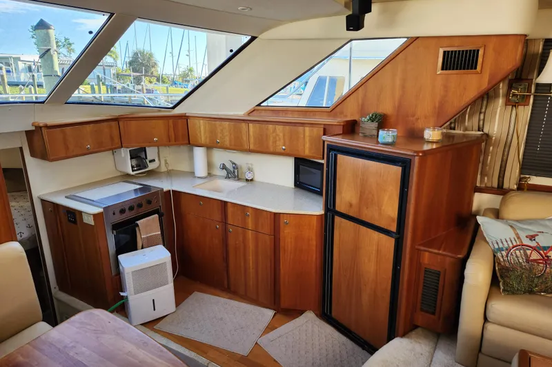 Slide: The Image of 2001 Silverton 392 Motor Yacht interior kitchen with wood cabinetry and modern appliances. - 18