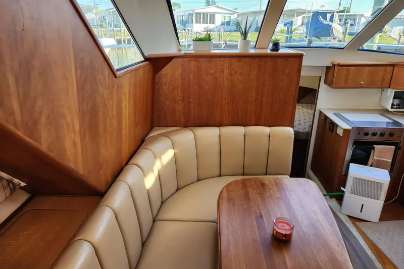 Slide: The Image of Interior of 2001 Silverton 392 Motor Yacht with cozy seating and wooden finishes. - 19