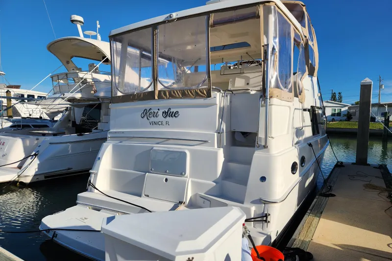 Slide: The Image of 2001 Silverton 392 Motor Yacht docked in sunny marina, rear view. - 2