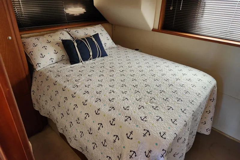 Slide: The Image of Cozy bedroom in 2001 Silverton 392 Motor Yacht with anchor-themed bedding. - 21