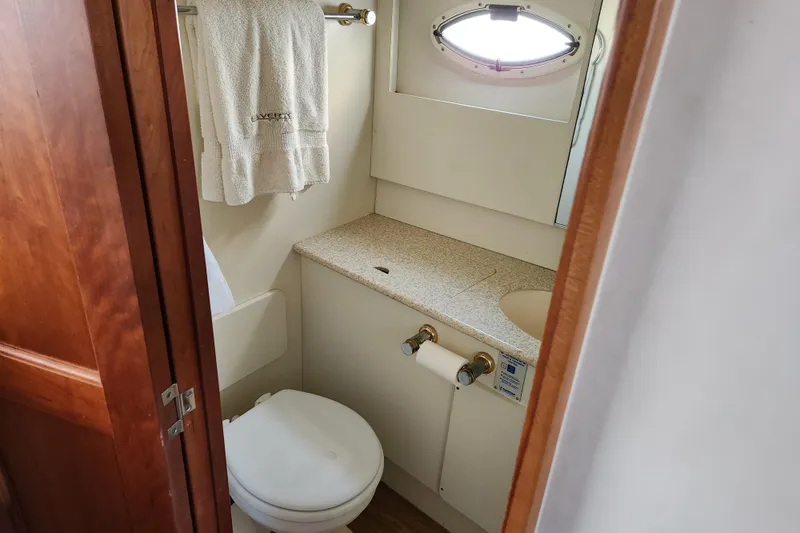 Slide: The Image of Bathroom interior of 2001 Silverton 392 Motor Yacht with porthole and towel rack. - 22