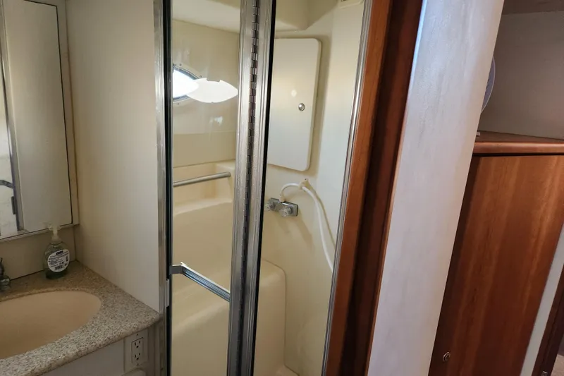Slide: The Image of Bathroom interior of 2001 Silverton 392 Motor Yacht with shower and sink. - 23