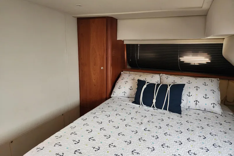 Slide: The Image of Interior cabin of 2001 Silverton 392 Motor Yacht with anchor-themed bedding. - 24