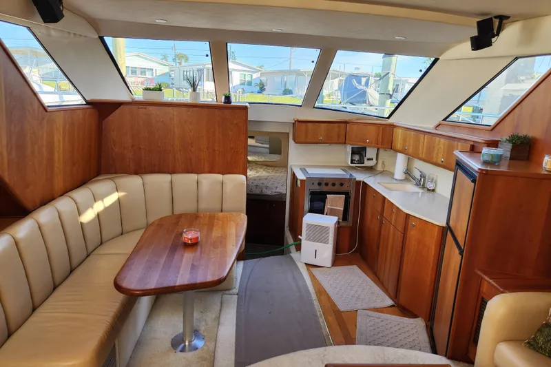 Slide: The Image of Interior of 2001 Silverton 392 Motor Yacht with kitchen and seating area. - 25