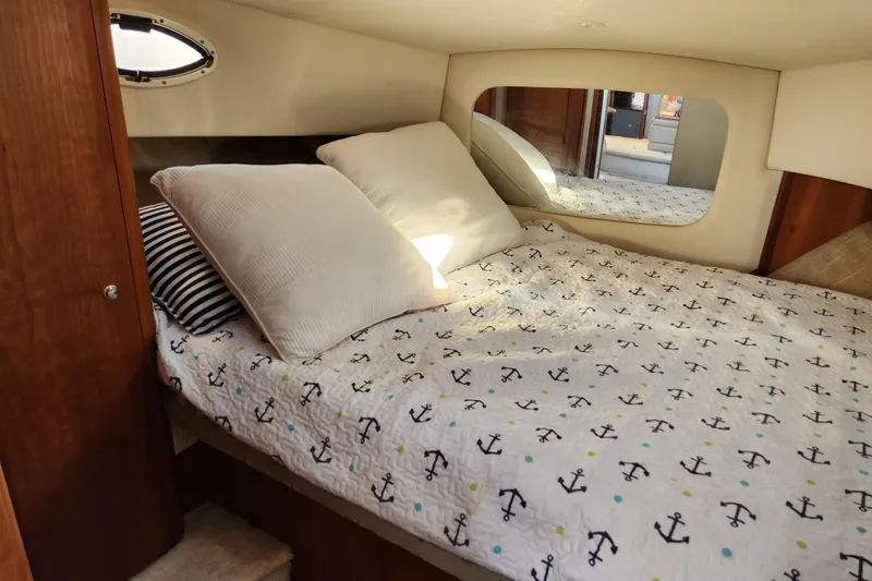 Slide: The Image of Cozy bedroom in 2001 Silverton 392 Motor Yacht with anchor-patterned bedding. - 26