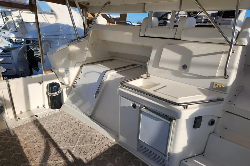 Slide: The Image of 2001 Silverton 392 Motor Yacht interior with seating and kitchenette area. - 3
