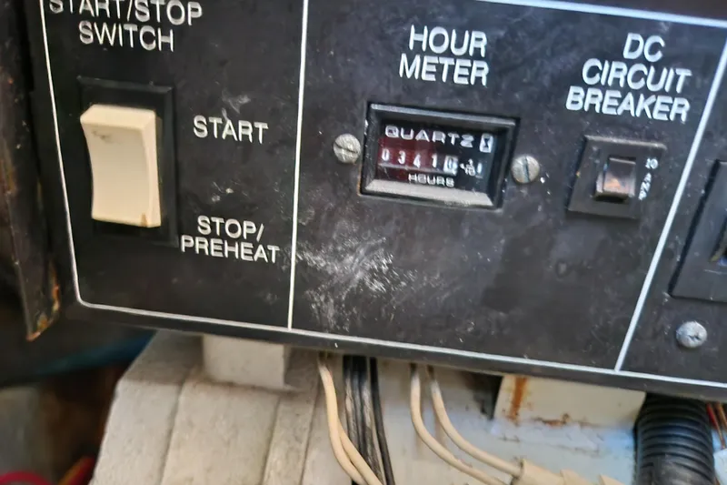 Slide: The Image of Control panel of a 2001 Silverton 392 Motor Yacht with hour meter and switches. - 37