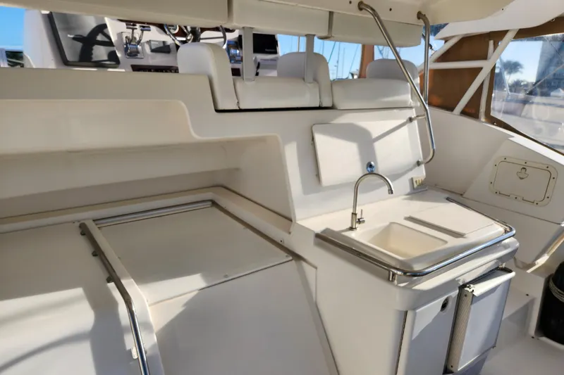 Slide: The Image of 2001 Silverton 392 Motor Yacht interior with sink and seating area. - 4