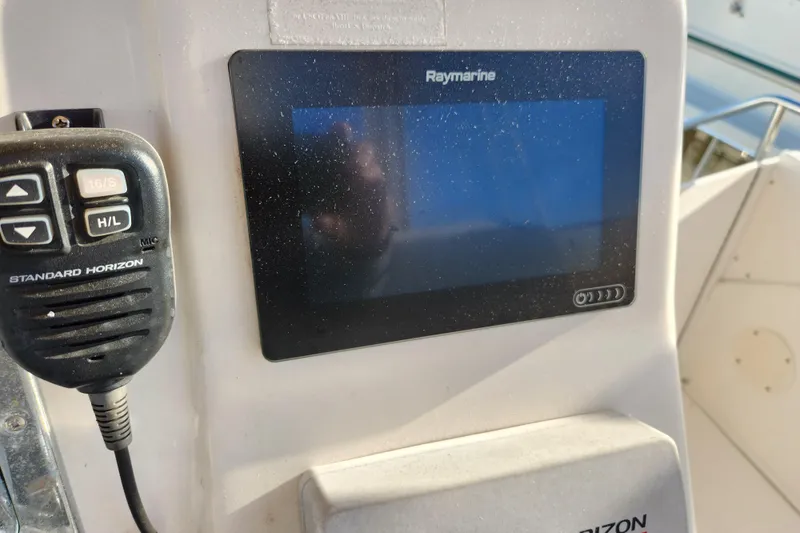 Slide: The Image of Control panel of a 2001 Silverton 392 Motor Yacht with Raymarine display and Standard Horizon radio. - 9