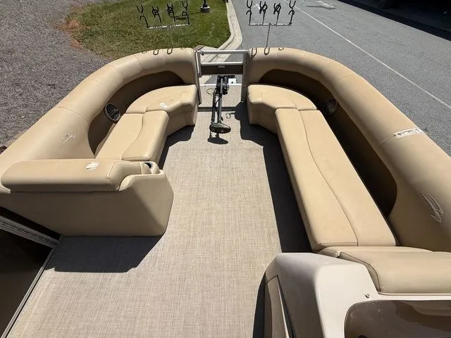 Slide: The Image of 2016 Bennington 22 SSX pontoon boat with beige seating and rod holders. - 12