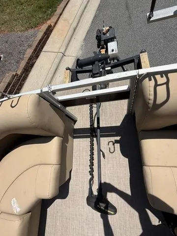 Slide: The Image of 2016 Bennington 22 SSX pontoon boat interior with beige seating and trolling motor. - 15