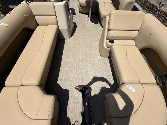 Slide: The Image of 2016 Bennington 22 SSX boat interior with beige seating and cup holders. - 17