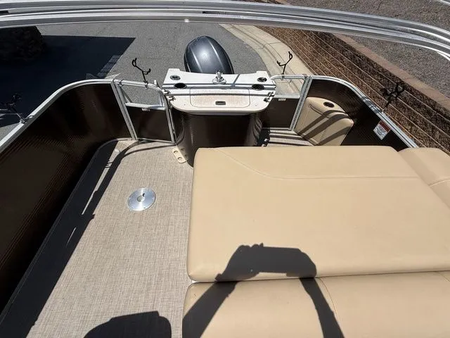 Slide: The Image of 2016 Bennington 22 SSX pontoon boat interior with beige seating and fishing rod holders. - 19