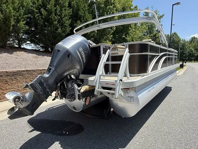 Slide: The Image of 2016 Bennington 22 SSX pontoon boat with Yamaha outboard motor, parked on a sunny day. - 3