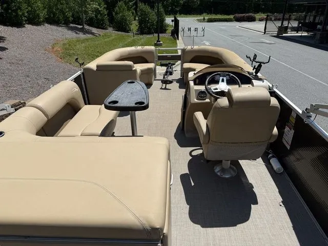 Slide: The Image of 2016 Bennington 22 SSX pontoon boat with beige seating and steering console. - 7