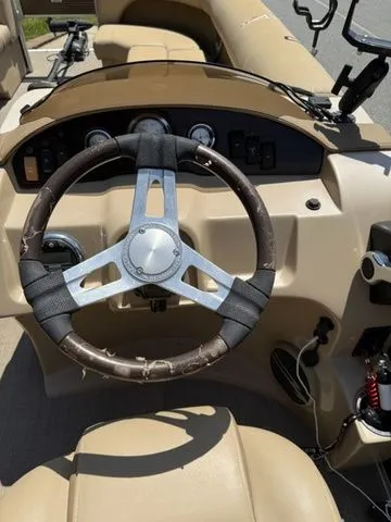 Slide: The Image of 2016 Bennington 22 SSX boat dashboard with steering wheel and control panel. - 10