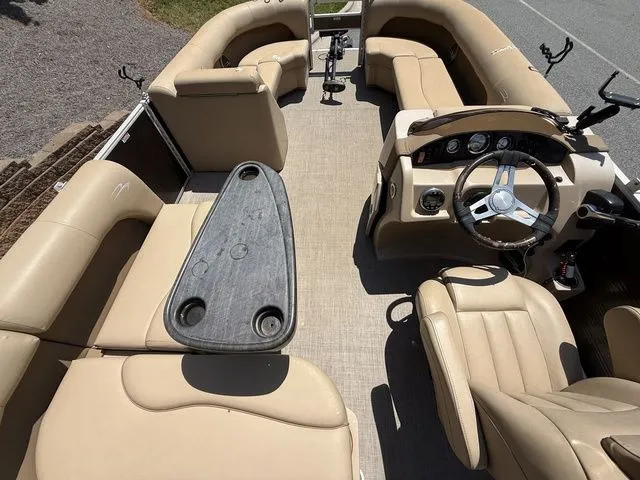 Slide: The Image of 2016 Bennington 22 SSX boat interior with beige seating and steering console. - 11