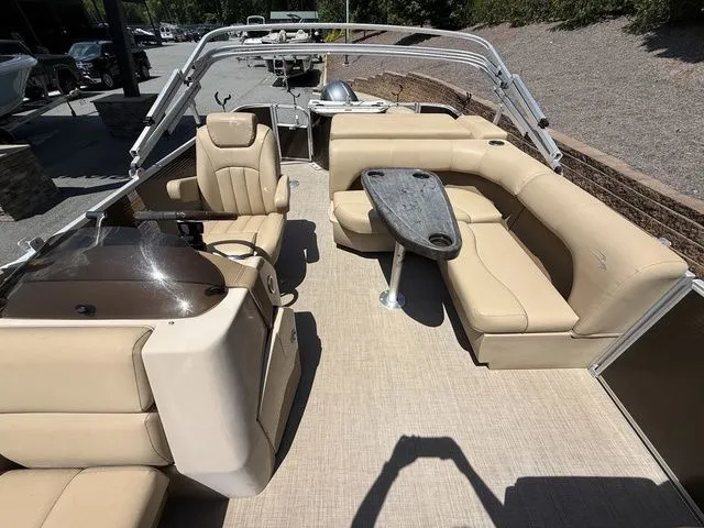 Slide: The Image of 2016 Bennington 22 SSX pontoon boat with beige seating and a central table. - 18