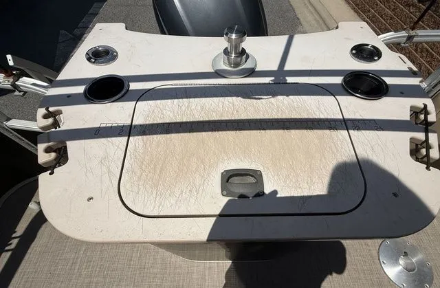 Slide: The Image of 2016 Bennington 22 SSX boat deck with cup holders and storage compartment. - 20