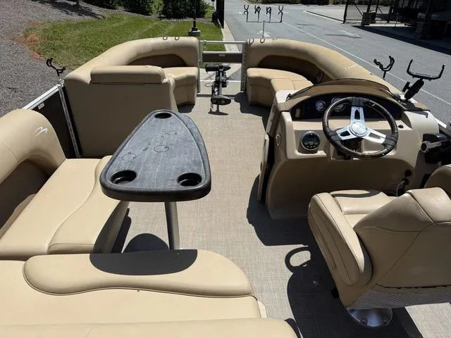Slide: The Image of 2016 Bennington 22 SSX pontoon boat interior with beige seating and steering console. - 9
