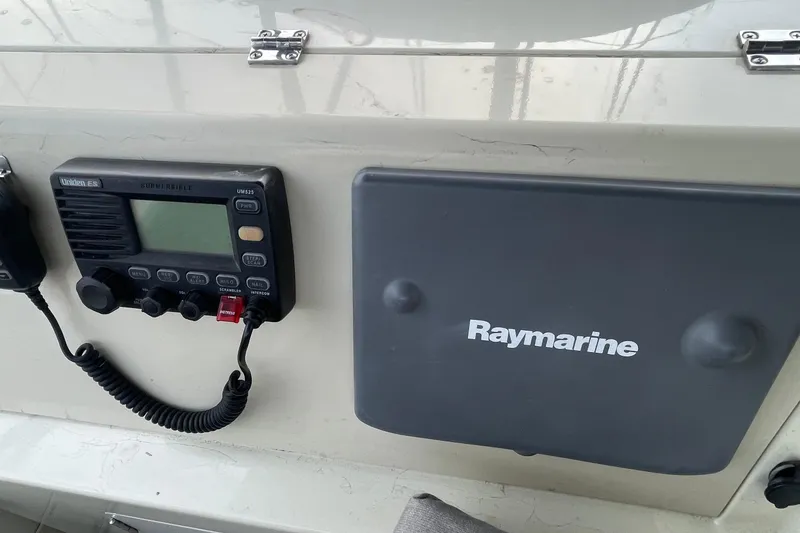 Slide: The Image of 1988 Tollycraft 34 Convertible Sedan dashboard with Raymarine equipment and Uniden marine radio. - 10