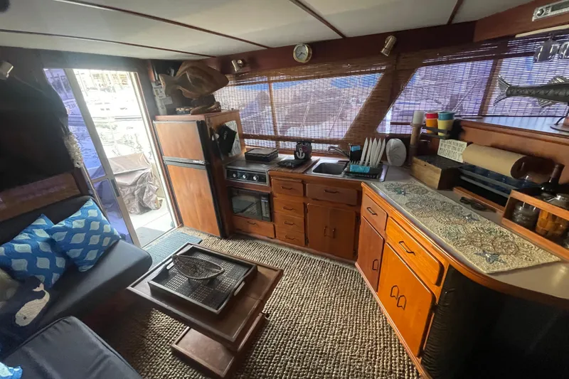 Slide: The Image of Interior of 1988 Tollycraft 34 Convertible Sedan with kitchen and seating area. - 11