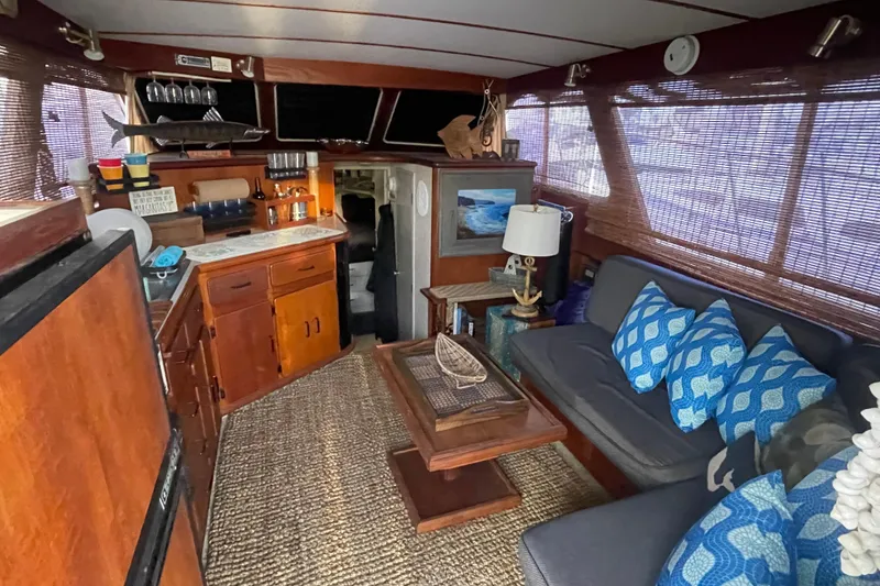 Slide: The Image of Interior of 1988 Tollycraft 34 Convertible Sedan with cozy seating and nautical decor. - 13