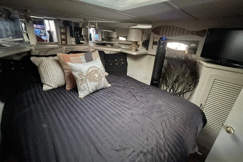 Slide: The Image of Cozy bedroom interior of 1988 Tollycraft 34 Convertible Sedan with decorative pillows and modern amenities. - 18