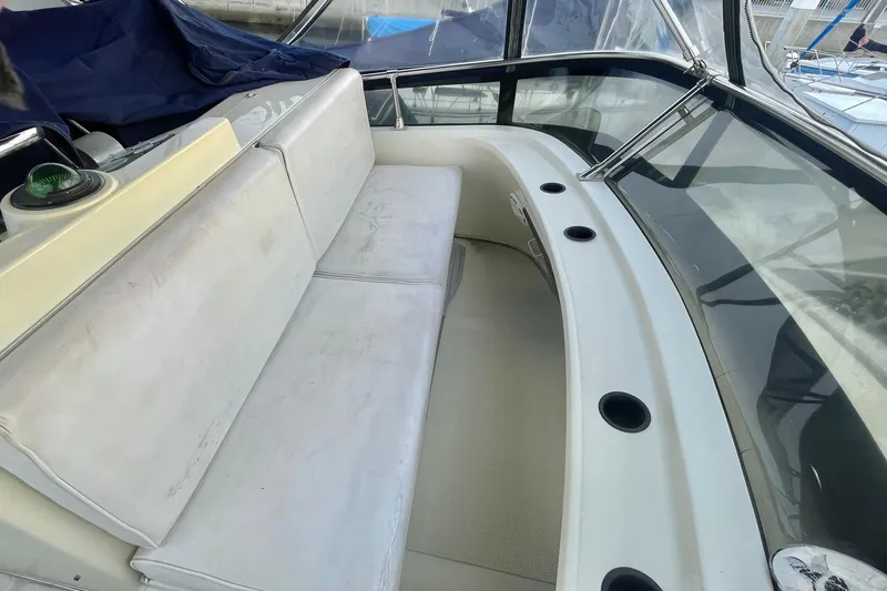 Slide: The Image of 1988 Tollycraft 34 Convertible Sedan interior with white seating and cup holders. - 5