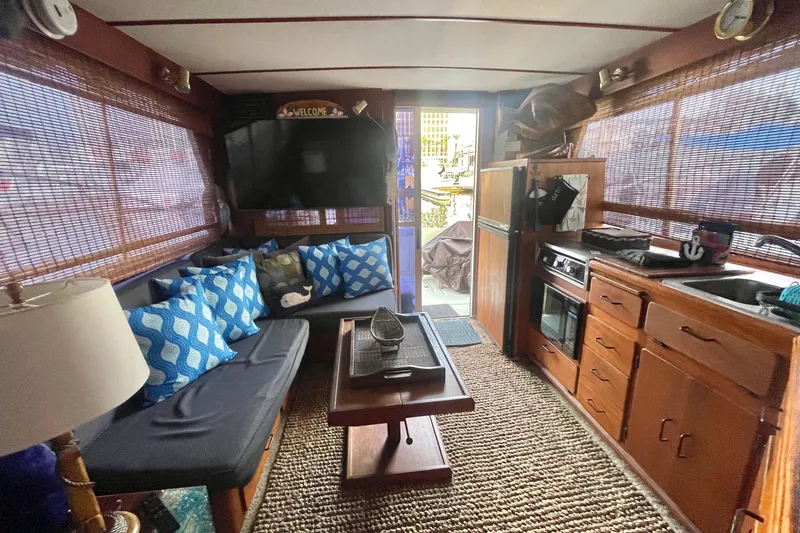 Slide: The Image of Interior of 1988 Tollycraft 34 Convertible Sedan with cozy seating and kitchen area. - 9