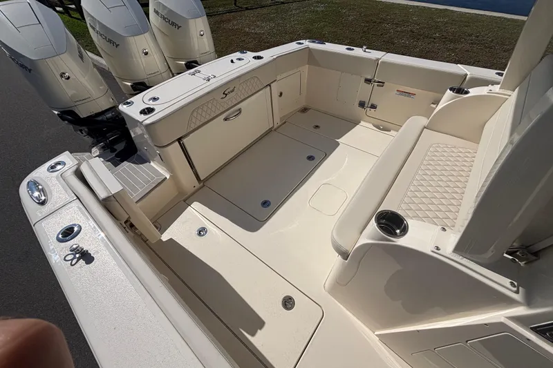 Slide: The Image of 2026 Scout 357 LXF boat deck with seating and Mercury engines. - 12