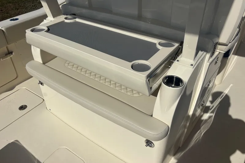 Slide: The Image of 2026 Scout 357 LXF boat interior with seating and cup holders. - 14