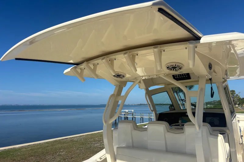 Slide: The Image of 2026 Scout 357 LXF boat with sleek design and advanced features by the water. - 18