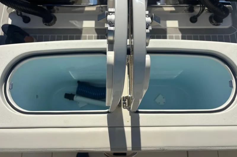 Slide: The Image of Open storage compartments on a 2026 Scout 357 LXF boat deck. - 20