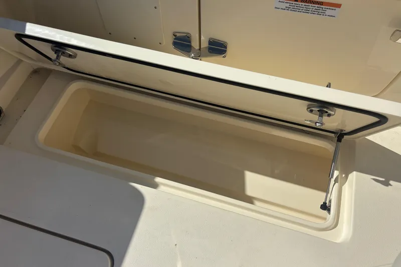 Slide: The Image of Open storage compartment on 2026 Scout 357 LXF boat, showcasing interior space. - 24