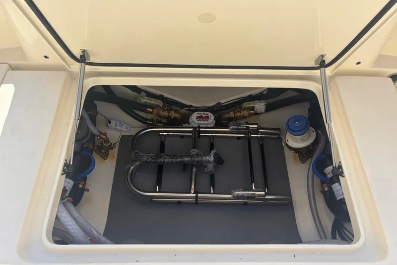 Slide: The Image of 2026 Scout 357 LXF boat compartment with equipment and wiring. - 25