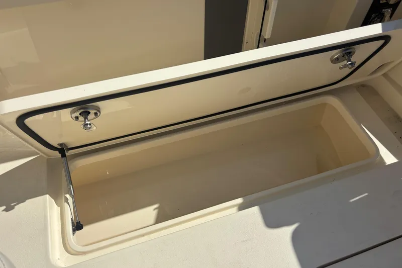 Slide: The Image of Open storage compartment on 2026 Scout 357 LXF boat, showcasing interior space. - 27