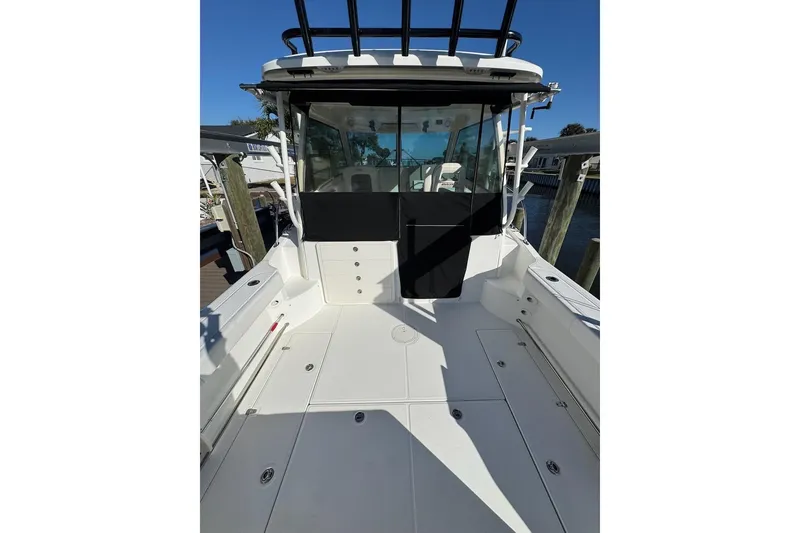 Slide: The Image of 2014 Boston Whaler 315 Conquest boat deck, featuring spacious seating and sleek design. - 12