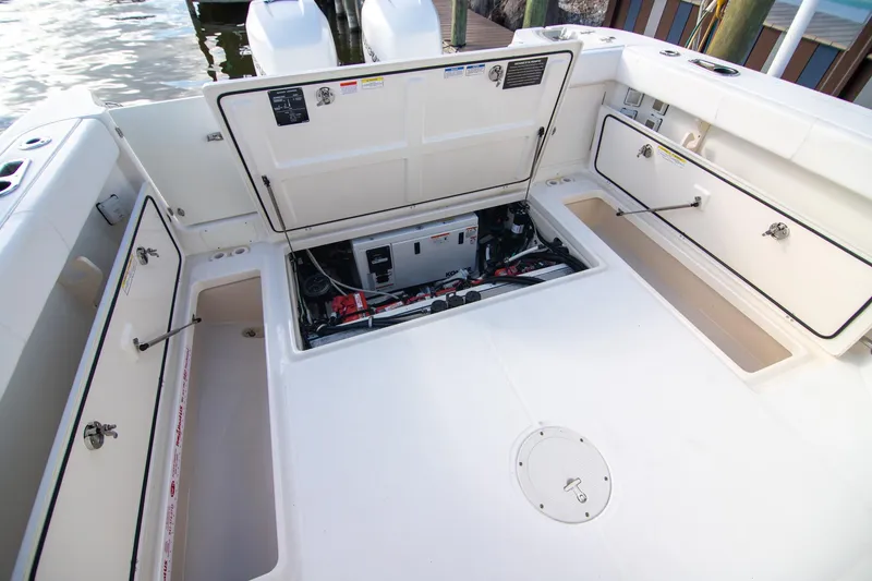 Slide: The Image of 2014 Boston Whaler 315 Conquest boat deck with open storage compartments. - 15