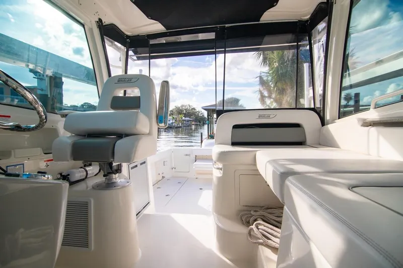 Slide: The Image of Interior view of 2014 Boston Whaler 315 Conquest boat, featuring seating and helm. - 19