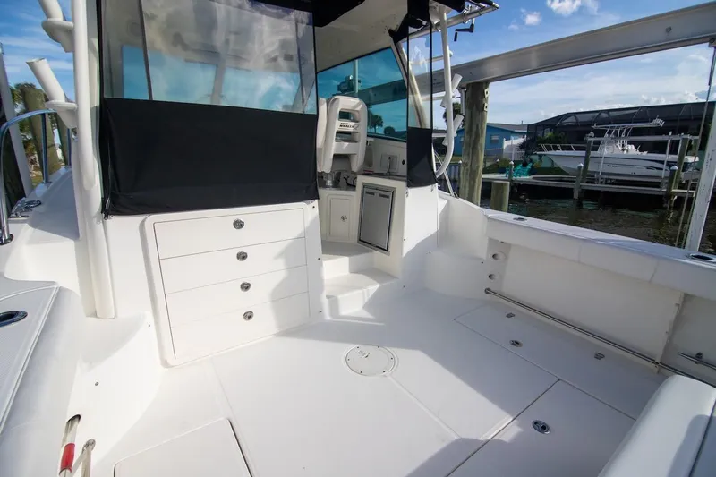 Slide: The Image of 2014 Boston Whaler 315 Conquest boat interior with storage and seating area. - 20
