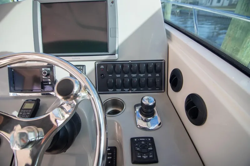 Slide: The Image of Control panel of 2014 Boston Whaler 315 Conquest boat with steering wheel and navigation equipment. - 27